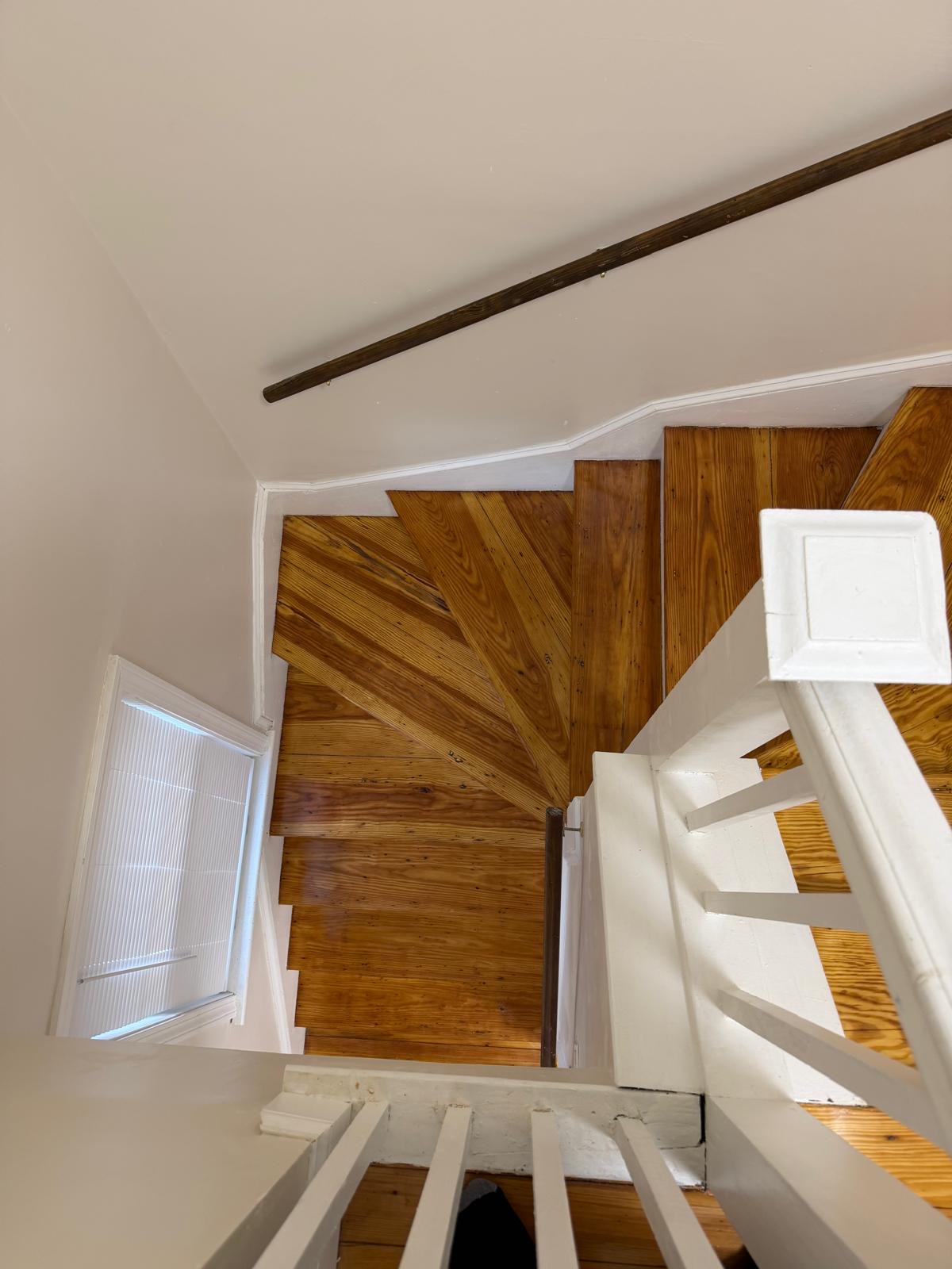 Photo 17 — Before — Hardwood Stairs Upper View